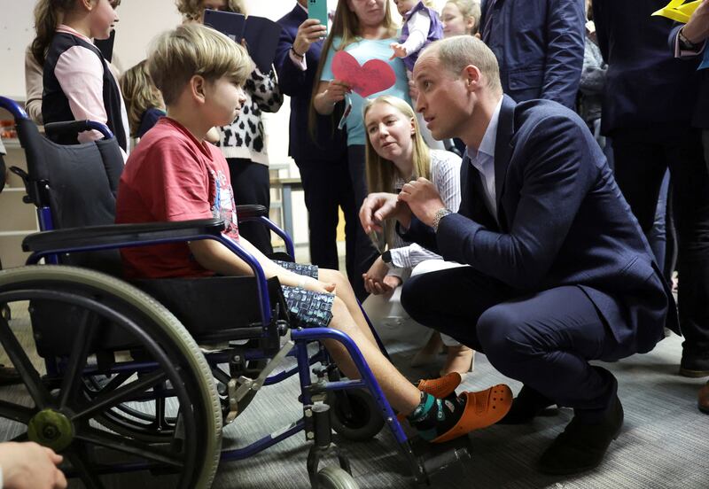 Prince William speaks with Marco, a young Ukrainian, about his experience moving to Poland at an accommodation centre in Warsaw. Reuters