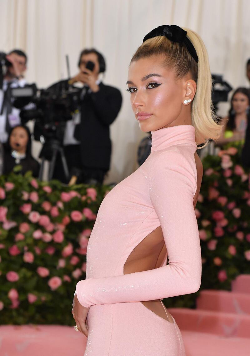 Model Hailey Rhode Bieber went sugary 1960s, with exaggerated winged eyeliner, shimmering blush and a slicked-back high pony, complete with black ribbon. AFP