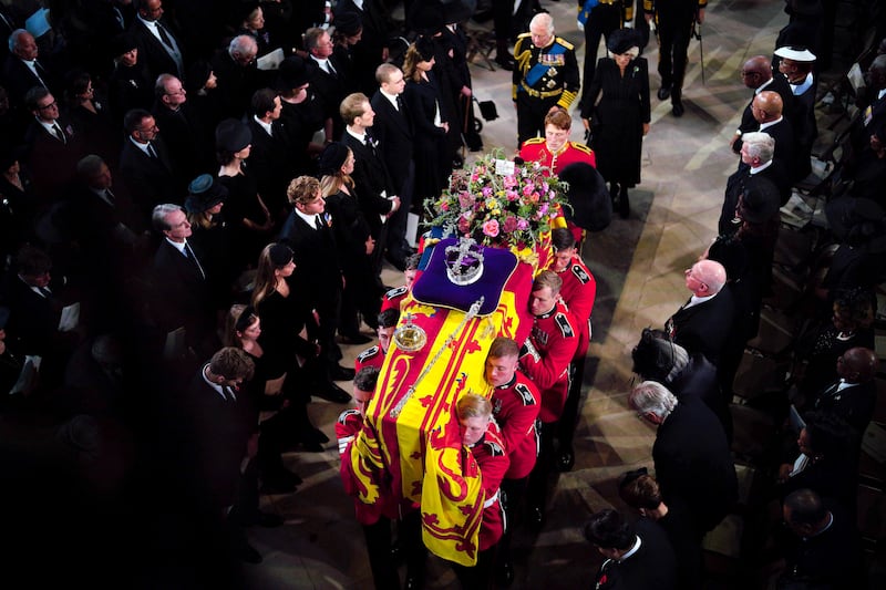 King Charles and the Queen Consort Camilla follow the coffin at St George's Chapel. AP