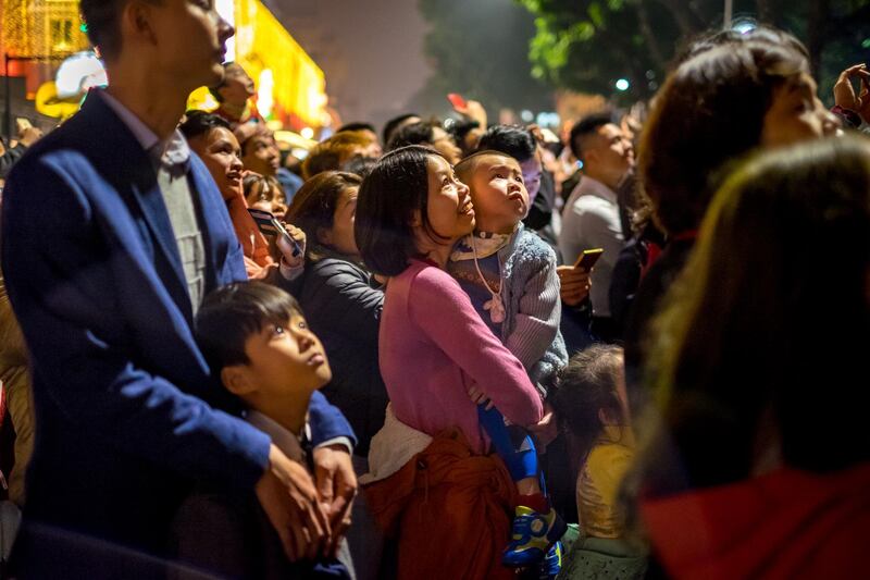 People watch a fireworks display in Hanoi, Vietnam. Linh Pham / Getty Images