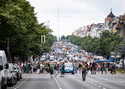 Demonstrators walk along Bismarckstrasse in Berlin during a protest against coronavirus restrictions. AP