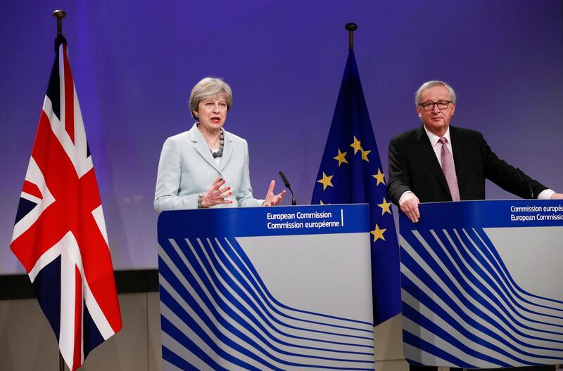 epa06375782 British Prime Minister Theresa May speaks at a press conference with EU Commission President Jean-Claude Juncker (L) prior to a meeting on Brexit Negotiations in Brussels, Belgium, 08 December 2017. Reports state that Theresa May is in Brussels after talks on the issue of the Irish border where she will meet with European Commission President Jean-Claude Juncker and EU negotiator Michel Barnier.  EPA/OLIVIER HOSLET