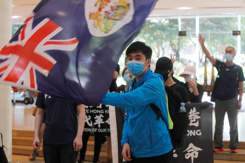 A protester waves a Hong Kong colonial flag in a shopping mall during a protest in Hong Kong. Protesters in Hong Kong got its government to withdraw extradition legislation last year, but now they're getting a more dreaded national security law. And the message from Beijing is that protest is futile. AP Photo