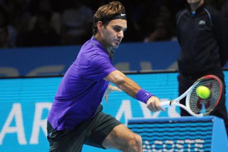 Roger Federer returns the ball against Janko Tipsarevic at the ATP Finals in London
