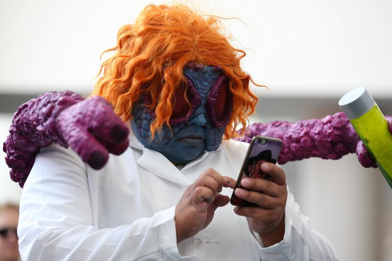 An attendee in costume checks his phone at Comic Con International in San Diego. Mike Blake / Reuters