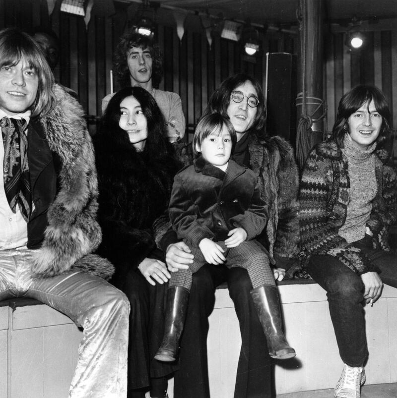 L-R: Rolling Stones guitarist Brian Jones, artist Yoko Ono and her husband, Beatles guitarist John Lennon, with his son Julian on his lap, guitarist Eric Clapton, and behind them singer Roger Daltrey of The Who, gather at Internel Studios in Stonebridge Park, Wembley, where they watched some of the circus acts who will appear in a television spectacular planned by the Rolling Stones, 'The Rolling Stones' Rock 'n' Roll Circus,' England, December 10, 1968. (Photo by Hulton Archive/Getty Images)   