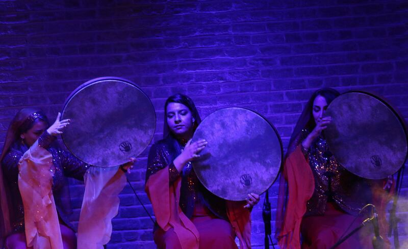 Sarmast musical group members play the daf at the concert. 