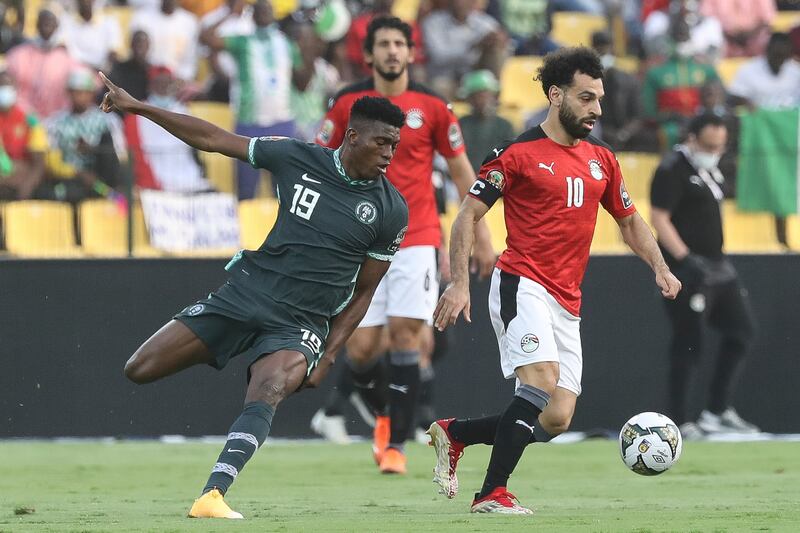 Egypt's Mohamed Salah, right, and Nigeria's Taiwo Awoniyi fight for the ball during the African Cup of Nations Group D soccer match between Egypt and Nigeria in Garoua, Cameroon, Tuesday, Jan.  11, 2022.  (AP Photo / Footografiia)