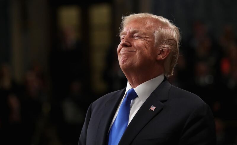 (FILES) In this file photo taken on January 30, 2018 US President Donald Trump smiles during the State of the Union address in the chamber of the US House of Representatives on  in Washington, DC. 
US President Donald Trump claimed vindication on February 3, 2018 in the probe into Russian interference in the 2016 White House election, following the release of a controversial memo implying partisanship at the Federal Bureau of Investigation.The declassified Republican document released February 3, 2018 claimed that Democrat-funded research prompted the FBI to spy on a former Trump campaign aide."This memo totally vindicates 'Trump' in probe," the president tweeted, referring to himself in the third person. 
 / AFP PHOTO / POOL / Win McNamee