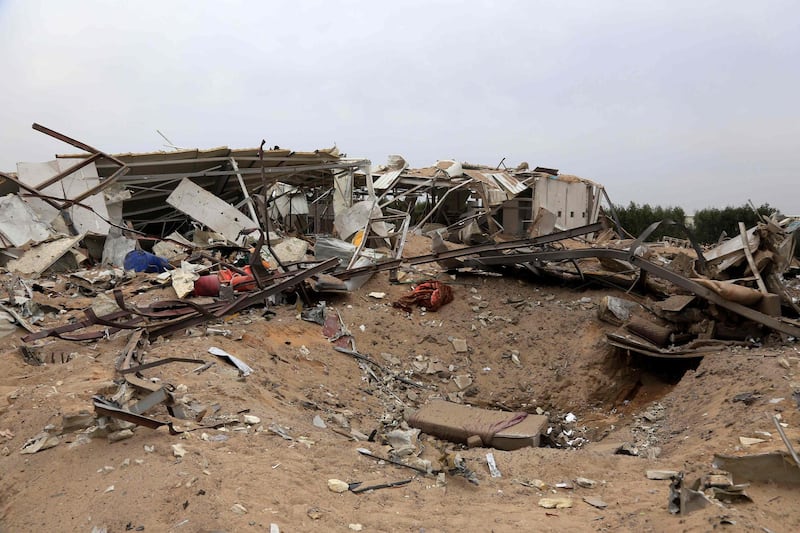 A picture taken on March 13, 2020 shows a crater and destruction in the Iraqi shrine city of Karbala, in one of the areas targeted by US military air strikes against a pro-Iranian group in Iraq following the deaths of two Americans and a Briton in a rocket attack the previous night on a US base in Taji.
 The US operation targeted five weapons facilities of the Kataeb Hezbollah armed faction across Iraq, the Pentagon said in a statement, one of them in Karbala, south of Baghdad. Wednesday's attack on the Taji air base was the 22nd on US installations in Iraq, including the American embassy, since late October. While there was no immediate claim of responsibility, Washington has blamed Iran-backed factions from the Hashed al-Shaabi network, a state-sponsored umbrella group that includes Kataeb Hezbollah, for recent similar violence.
 / AFP / Mohammed SAWAF
