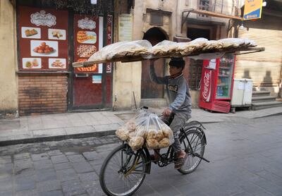 A vendor balances a tray of Egyptian traditional flatbread in Old Cairo district, Egypt, in March. Food security in Africa will be discussed ahead of Cop27. AP