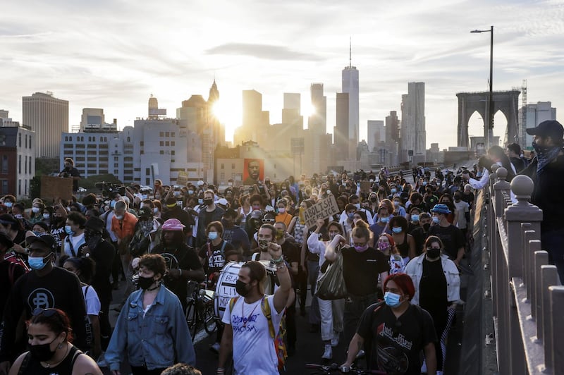 Protesters march on the Brooklyn Bridge during a demonstration on the first anniversary of the death of George Floyd, in New York. Reuters