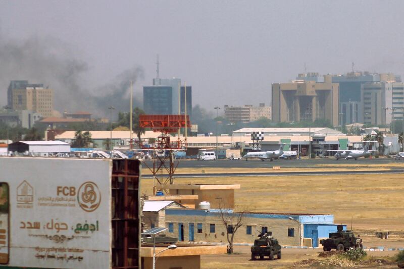 Smoke rises near Khartoum airport as clashes in the city continue. Flydubai and Emirates have extended flight suspensions to the country. AFP