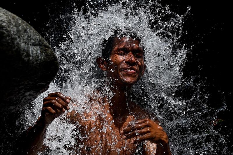 A man bathes in a stream at the Wuaraira Repano mountain, also called 'El Avila', in Caracas, Venezuela. AFP