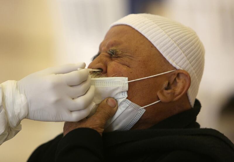 A health worker takes a swab from a man to be tested for the coronavirus disease in the town of Hasbaya, Lebanon. Reuters