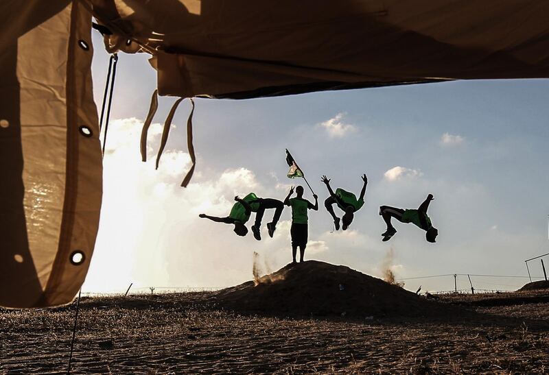 Palestinian youths practice their parkour skills at the Israel-Gaza border in the southern Gaza Strip. Said Khatib / AFP