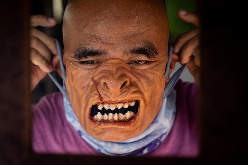 TV prosthetics artist Rene Abelardo tries on a sample of his prosthetic face mask, his latest creation amid the coronavirus outbreak in San Pedro, Laguna, Philippines. All photos from Reuters