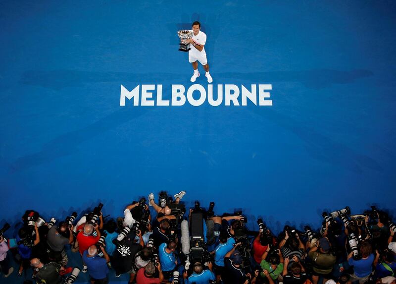 FILE PHOTO: Tennis - Australian Open - Men's singles final - Rod Laver Arena, Melbourne, Australia, January 28, 2018. Switzerland's Roger Federer poses with the trophy after winning the final against Croatia's Marin Cilic. REUTERS/Toru Hanai/File Photo