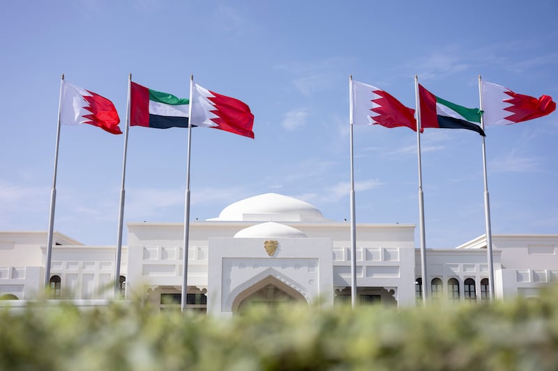 UAE and Bahraini flags fly in front of Sakhir Air Base.
