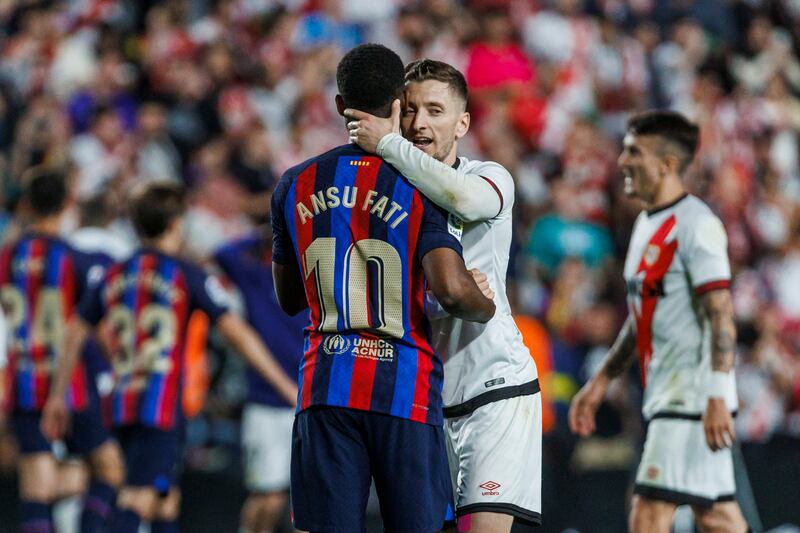Rayo's Ivan Balliu, right, embraces Barcelona's Ansu Fati at the end of the match. AP Photo