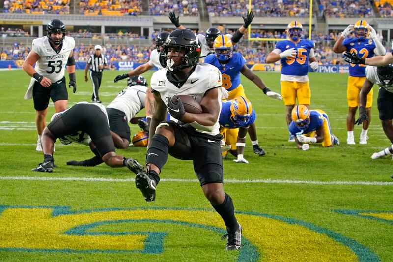 Cincinnati running back Corey Kiner scores a touchdown against Pittsburgh during the first half of an NCAA college football game in Pittsburgh. AP