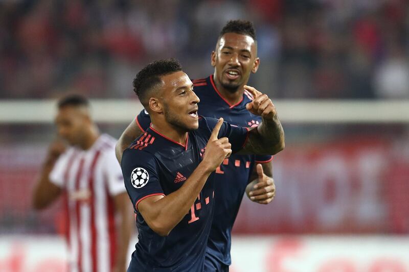 PIRAEUS, GREECE - OCTOBER 22: Corentin Tolisso of FC Bayern Munich celebrates with teammate Jerome Boateng after scoring his team's third goal during the UEFA Champions League group B match between Olympiacos FC and Bayern Muenchen at Karaiskakis Stadium on October 22, 2019 in Piraeus, Greece. (Photo by Alexander Hassenstein/Bongarts/Getty Images)