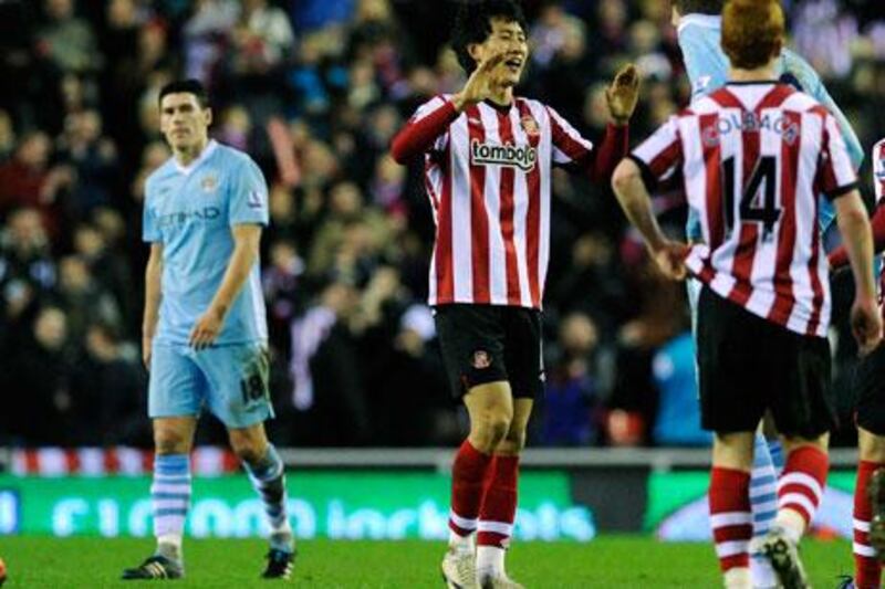 Sunderland's Ji Dong-Won, centre, celebrates with teammates after his goal in stoppage time shocked Manchester City.