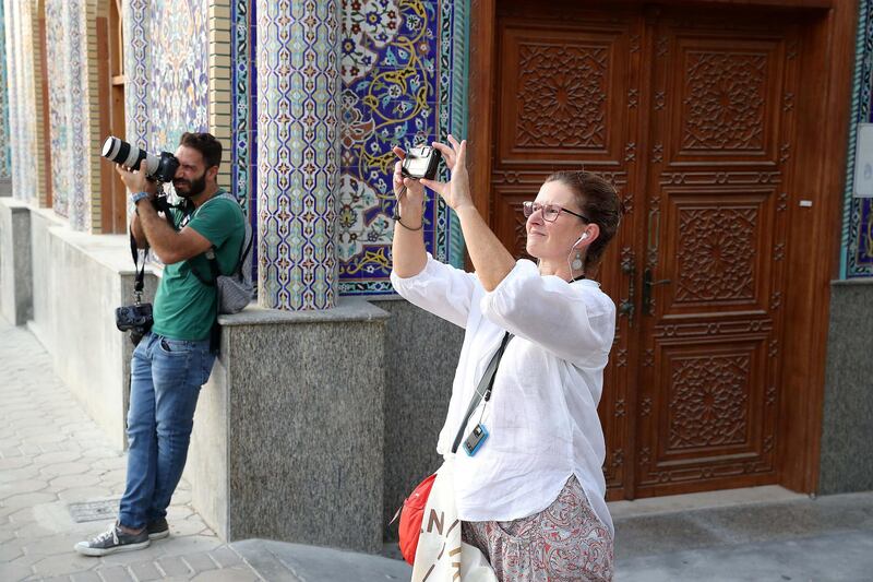 DUBAI , UNITED ARAB EMIRATES , MAY 23 – 2018 :- Participants taking photos during the Unseen Trails Iftar Walk presented by Gulf Photo Plus and Frying Pan Adventures in Bur Dubai area in Dubai.  ( Pawan Singh / The National )  For Weekender