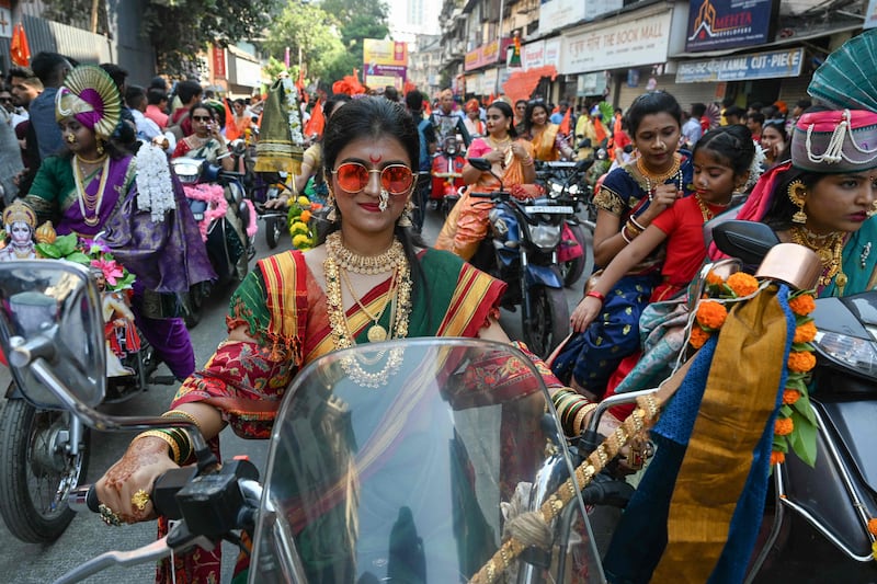 Women dressed in traditional oufits ride motorcycles during a procession to mark Gudi Padwa, or the Maharashtrian New Year, in Mumbai, India. AFP