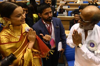 Bollywood actor Kangana Ranaut greets Rajinikanth at the 67th National film Awards ceremony. AFP