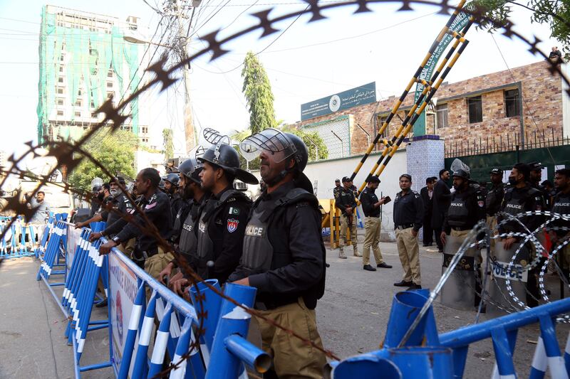Police stands guard outside the provincial election commission office in Karachi. EPA
