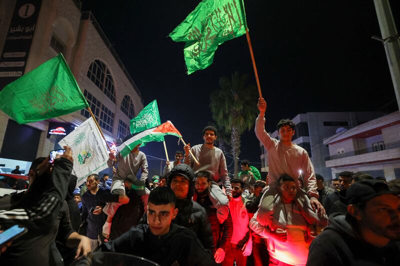 Palestinians released by Israel are carried along a street as crowds celebrate. AFP