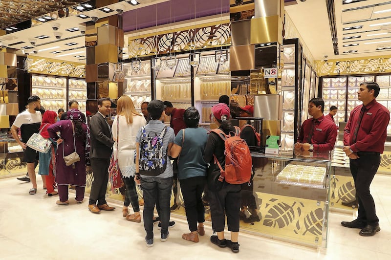 DUBAI , UNITED ARAB EMIRATES , Mar 10 – 2020 :- Customers looking for gold jewellery at the Kanz jewellery shop in Dubai Gold Souk in Deira Dubai. ( Pawan Singh / The National ) For News/Online Story by Kelly