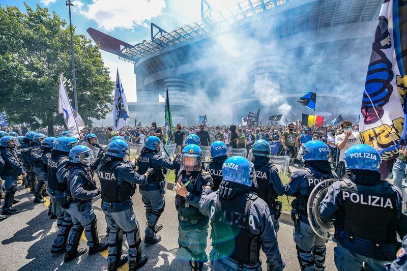 Police watch Inter fans before the match. EPA