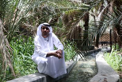 Abdulrahman Al Nuaimi, world heritage site manager at the Department of Culture and Tourism, at the falaj system that runs through Al Ain Oasis.