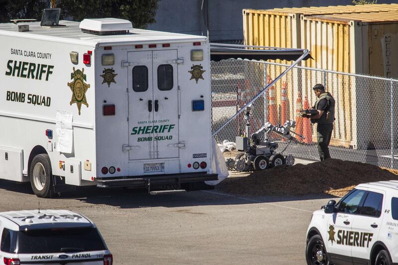 A bomb squad member prepares a robot at the rail yard in San Jose. An VTA employee is suspected of carrying out the shooting. AFP