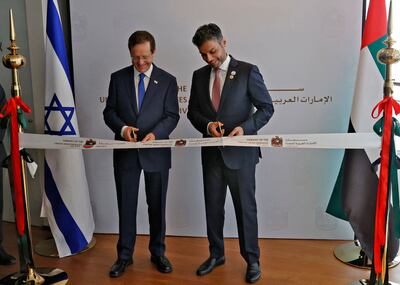 Israeli President Isaac Herzog, left, and Emirati Ambassador to Israel Mohamed AL Khaja cut the ribbon at the new UAE embassy in Tel Aviv. AFP