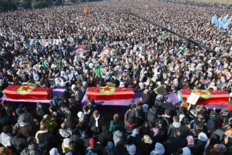 The coffins of three Kurdish activists are carried through a crowd of tens of thousands of people at their funeral in Diyarbakir, sourtheastern Turkey.