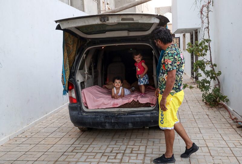'This is my bedroom,' Mr Aguil says of the cramped vehicle.  Its back seats have been removed to make space for him and his two young children. 'In the morning I wake up with a terrible backache. That's our life these days.'