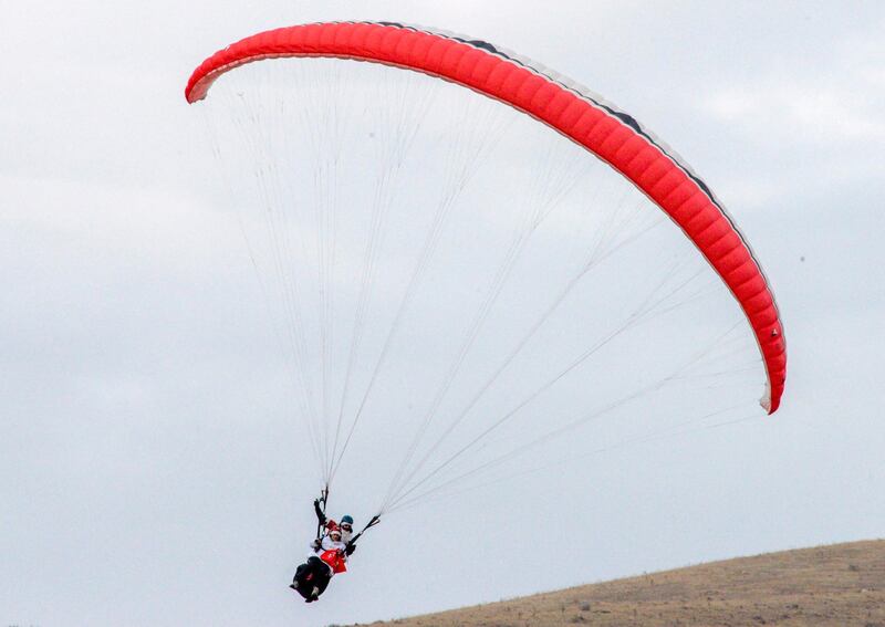 A paraglider wearing a Santa Claus costume lands near the village of Akunq, some 15 kilometres outside of Yerevan.  AFP