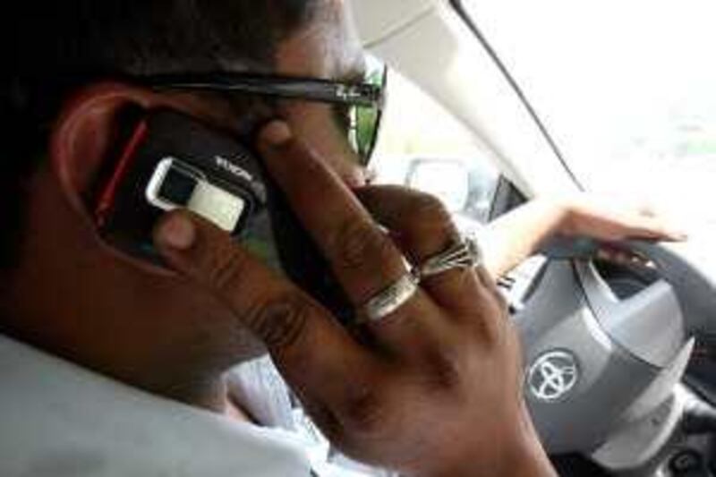 


DUBAI, UNITED ARAB EMIRATES Ð July 15: Motorist still using mobile phones while driving on the roads in the UAE despite various Traffic awareness campaigns, Fines and Accidents on the roads.  (Photo Illustration by Pawan Singh / The National) PLEASE NOTE CREDIT MUST READ "PHOTO ILLUSTRATION" AS THIS IS A POSED PICTURE *** Local Caption ***  PS08- CAR & PHONE.jpg