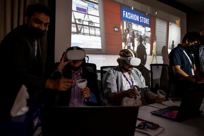 Guests try out Magnati's MetaV metaverse platform using Oculus headsets during its launch at First Abu Dhabi Bank's head office on Thursday. Vidhyaa Chandramohan / The National