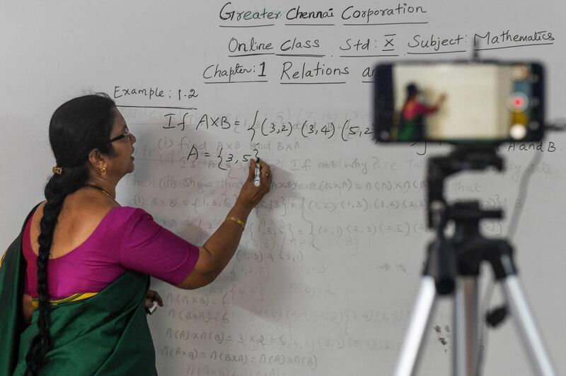 A school teacher gives a live streaming online class at a government  school after the government eased a nationwide lockdown imposed as a preventive measure against the COVID-19 coronavirus, in Chennai on June 3, 2020. / AFP / Arun SANKAR                        
