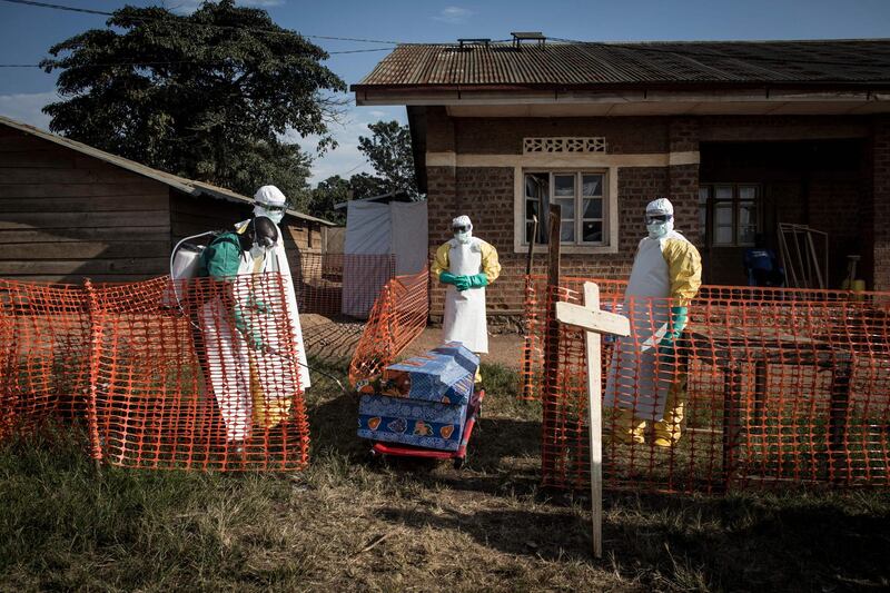 Medical workers disinfect the coffin of a deceased unconfirmed Ebola patient inside an Ebola Treatment Centre run by The Alliance for International Medical Action (ALIMA) on August 13, 2018, in Beni. AFP