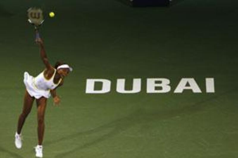 Venus Williams of the US serves the ball to sister and compatriot Serena Williams during their semi-final match.