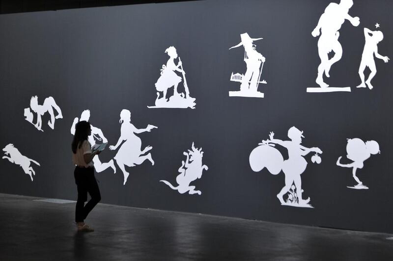 A visitor looks at the artwork The Sovereign Citizens Sesquicentennial Civil War Celebration by Kara Walker in the Unlimited section of Art Basel. Art Basel one of the most prestigious art fairs in the world, which runs until June 22, 2014 and will showcase the work of more than 4,000 artists selected by 300 leading galleries. Harold Cunningham / Getty Images
