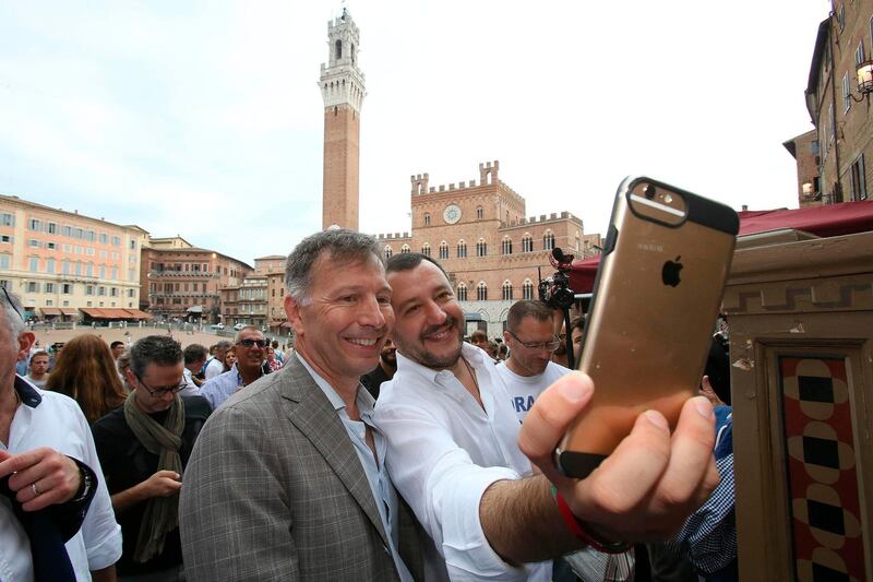 Italian Interior Minister Matteo Salvini poses for a 'selfie' with the candidate mayor of Siena Luigi De Mossi, left, during an electoral rally in Siena, Italy, Friday, June 22, 2018. (Fabio Di Pietro/ANSA via AP)