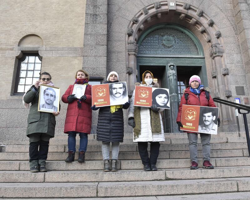 People demonstrate in November 2021 outside the Stockholm District Court, where Iranian former prison official Hamid Noury was questioned before being put on trial for alleged war crimes. TT News Agency / AFP