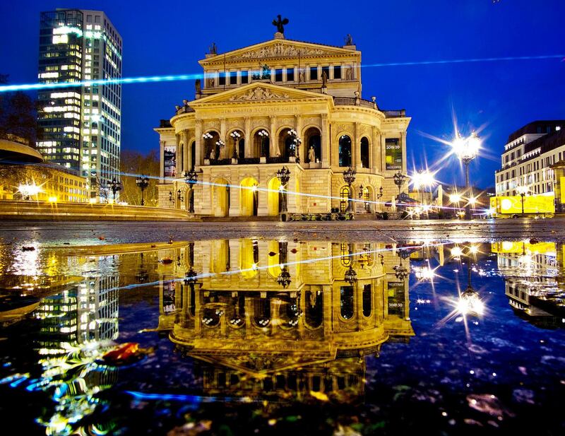 The Old Opera is reflected in a puddle in Frankfurt, Germany. AP Photo