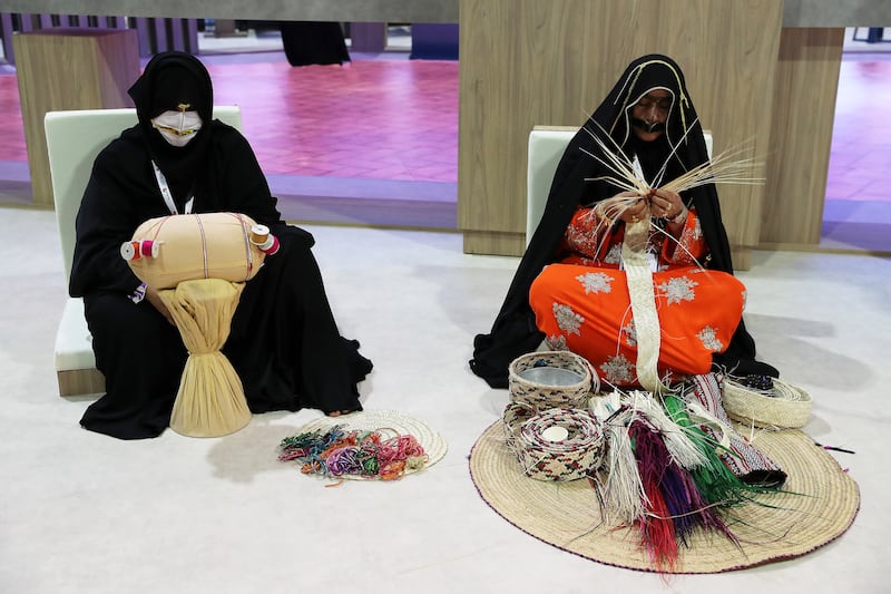 Artists showcasing handmade items at the Abu Dhabi stand.